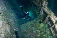 Diver penetrating HMCS Yukon wreck / San Diego, California: Diver exiting the ship's galley, HMCS Yukon